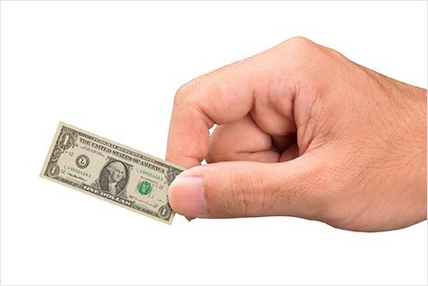 Hand holding miniature dollar
