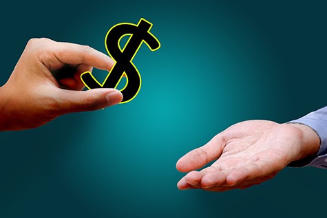 Hands giving and receiving dollars sign ©iStockphoto.com/wutwhanfoto